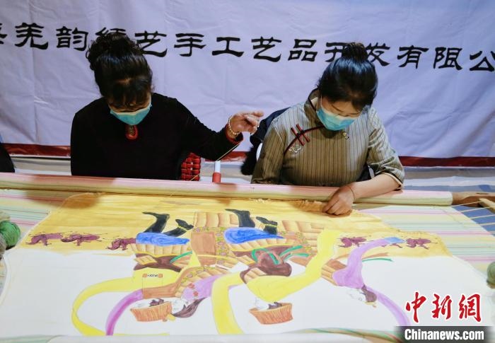 圖為皮繡藝人在市集上“秀”指尖技藝?！●R銘言 攝