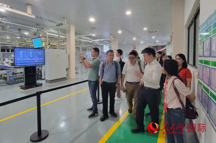 廣汽埃安工作人員向外媒記者進(jìn)行介紹。人民網(wǎng) 寧玉瑛攝