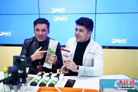 2023年3月，甘肅省慶陽市環(huán)縣電商創(chuàng)業(yè)孵化基地內(nèi)，來自蘭州文理學(xué)院的塔吉克斯坦留學(xué)生正在協(xié)助主播直播帶貨當(dāng)?shù)剞r(nóng)特產(chǎn)品。李亞龍 攝