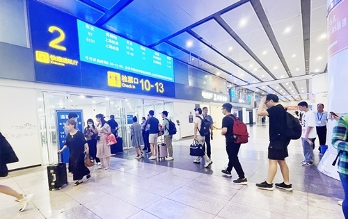 在快速進站廳前排隊等待檢票的旅客。人民網(wǎng)記者 喬雪峰攝