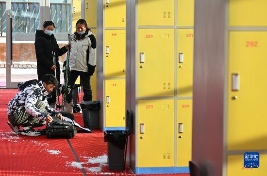 12月21日，游客在滑雪服務(wù)大廳整理滑雪裝備。