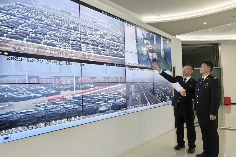 海關(guān)關(guān)員視頻巡查出口汽車場地。李進攝
