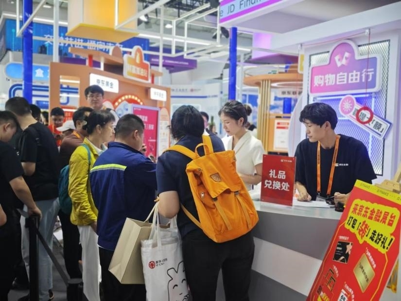 觀眾在金融服務(wù)展區(qū)體驗展臺的互動活動。人民網(wǎng)記者 黃盛攝