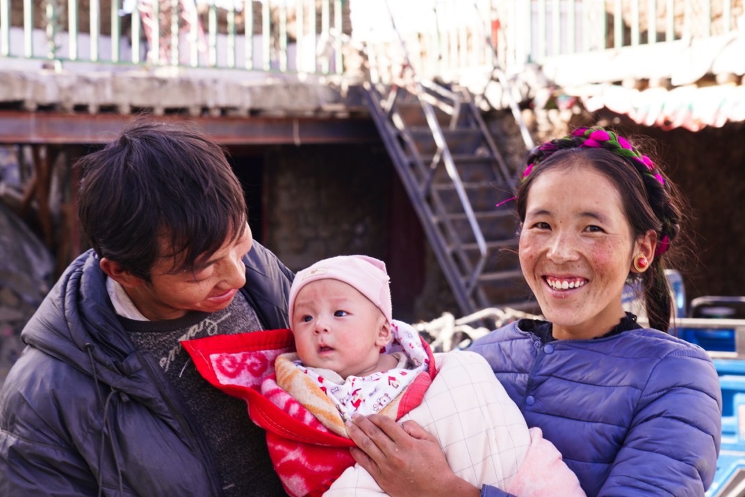 1月11日，在西藏日喀則市人民醫(yī)院，受災(zāi)群眾抱著自己在地震中受傷的孩子康復(fù)出院。人民日?qǐng)?bào)記者徐馭堯攝