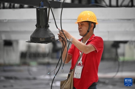 4月4日，工作人員在海南國(guó)際會(huì)展中心內(nèi)布設(shè)燈光。