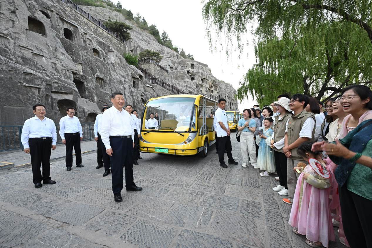 5月19日，習近平在洛陽龍門石窟考察時，同游客親切交流。